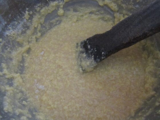 Mixing cake ingredients with a wooden stick mixing the eggs and butter or margarine